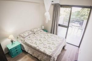 a small bedroom with a bed and a window at Recreio Paradisíaco in Rio de Janeiro +15 photos