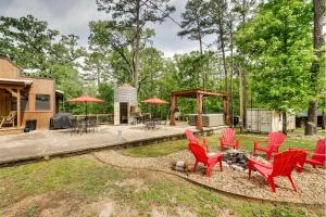 a group of red chairs and tables in a yard at Western Daze Broken Bow Cabin in Hochatown! in Stephens Gap