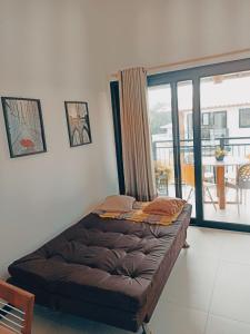 プライア・ド・フォルテにあるApto Top na Praia do Forteのバルコニー付きの客室のベッド1台分です。