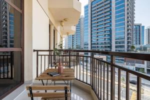 a balcony with two benches and a table on it at Chez Eric in Dubai