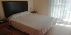 Posteľ alebo postele v izbe v ubytovaní Ático playa Vera, Costa Rey, jacuzzi y 3 piscinas, 2 terrazas 50m