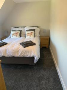 a bedroom with a bed with two pillows on it at Tigh Na Cille Studio, Taynuilt in Taynuilt