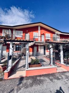 Edificio naranja y blanco con balcón en Vacancuore, a casa di Giada, en Bastia Umbra