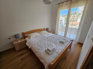 Postel nebo postele na pokoji v ubytování AS Apartments Rafailovici