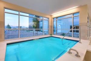 a swimming pool in a house with windows at TownePlace Suites by Marriott Salt Lake City Draper in Draper