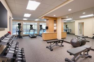 a gym with a lot of exercise equipment and chairs at TownePlace Suites by Marriott Salt Lake City Draper in Draper