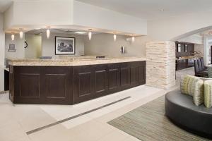 a large lobby with a bar with a couch at Residence Inn Chicago O'Hare in Rosemont