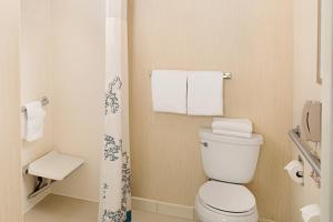 a small bathroom with a toilet and towels at Residence Inn Chicago O'Hare in Rosemont