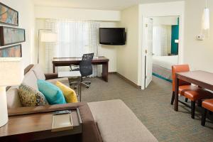 a hotel room with a couch and a desk at Residence Inn Chicago O'Hare in Rosemont