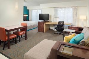 a hotel room with a bed and a living room at Residence Inn Chicago O'Hare in Rosemont