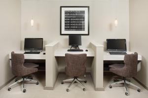 two desks with laptops and chairs in a room at Residence Inn Chicago O'Hare in Rosemont