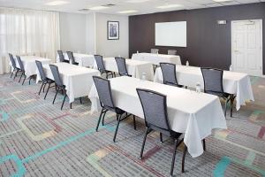 a conference room with white tables and chairs at Residence Inn Chicago O'Hare in Rosemont