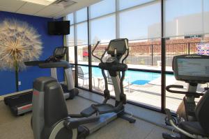 a gym with two exercise bikes and a swimming pool at SpringHill Suites by Marriott Las Vegas North Speedway in Las Vegas