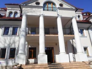 a large white house with columns at Apartament Brandy Radowid in Zakopane
