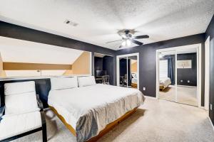 a bedroom with a bed and a ceiling fan at Country Village Condo in Humble