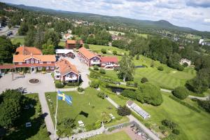 an aerial view of a house with a golf course at Järvsöbaden in Järvsö