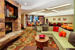 a living room with a couch and a fireplace at Courtyard by Marriott St. George in St. George