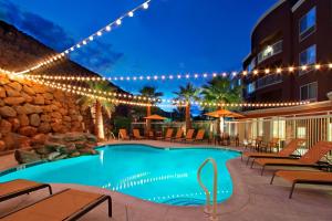 a pool at a hotel at night with lights at Courtyard by Marriott St. George in St. George