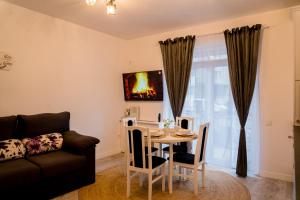 a living room with a table and a couch at Smiling Apartment in Cluj-Napoca