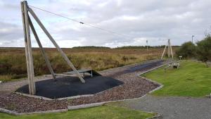 an empty park with a playground with swings at Newmarket in Stornoway