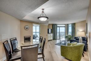 a living room with a table and chairs and a couch at Oceanfront 3BR Caribbean Resort Condo unit 2009 in Myrtle Beach