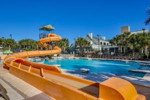 a large pool with an orange water slide at Oceanfront 3BR Caribbean Resort Condo unit 2009 in Myrtle Beach