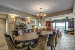a dining room and living room with a table and chairs at South Wind Penthouse 3 in Myrtle Beach