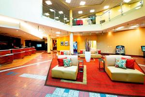 a lobby with couches and chairs on a red rug at Courtyard by Marriott Ottawa East in Ottawa