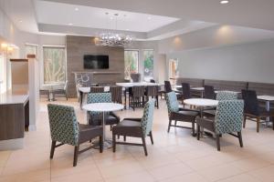 a restaurant with tables and chairs and a dining room at Residence Inn by Marriott San Antonio Airport/Alamo Heights in San Antonio