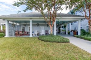 a front porch of a house with a table and chairs at Residence Inn by Marriott Wilmington Landfall in Wilmington