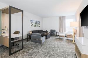 a living room with a couch and a table at SpringHill Suites by Marriott San Jose Fremont in Fremont
