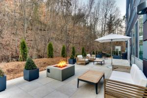 an outdoor patio with a fire pit and benches at Fairfield by Marriott Inn & Suites Dalton in Dalton
