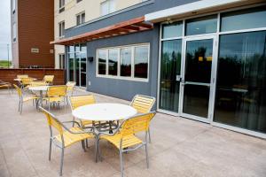 - un ensemble de tables et de chaises sur une terrasse dans l'établissement Fairfield Inn & Suites by Marriott Moncton, à Moncton