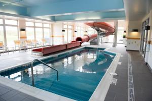 a large swimming pool with a slide in a building at Fairfield Inn & Suites by Marriott Moncton in Moncton