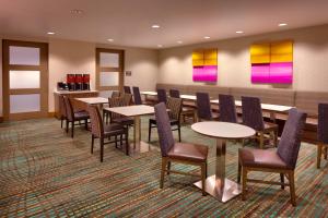 莫瑞的住宿－鹽湖城穆雷原住客棧，用餐室配有桌椅和色彩缤纷的绘画作品