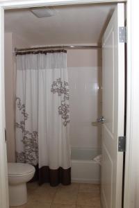 a bathroom with a shower curtain and a toilet at Residence Inn by Marriott Sebring in Sebring