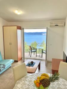 a living room with a view of the ocean at Apartments Sunspot 1 in Lokva Rogoznica
