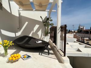 a black chair sitting on the side of a balcony at Terme Luxury Suite in Taormina