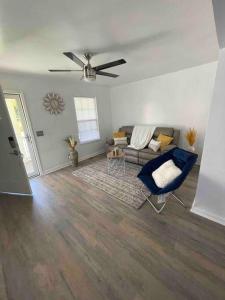 a living room with a couch and a ceiling fan at Look No Further! in Nashville