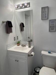 a bathroom with a white sink and a mirror at Look No Further! in Nashville