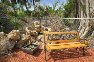 a wooden bench sitting next to a pile of rocks at Villa Holiday Sunrise II in Cape Coral