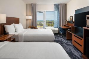 a hotel room with two beds and a desk and a window at Fairfield Inn & Suites by Marriott Destin in Destin