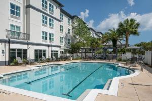 a pool at a hotel with chairs and trees at Fairfield Inn & Suites by Marriott Destin in Destin