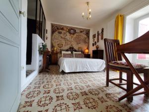 a bedroom with a bed and a large wall at La Dolce Vita - Chambre Marco Polo in Montpeyroux +20 photos