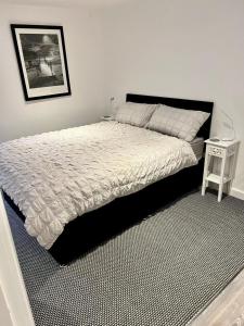 a bedroom with a large bed and a table at Basement Studio by the Bay in Morecambe