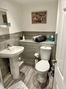 a bathroom with a white toilet and a sink at Basement Studio by the Bay in Morecambe