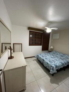 a bedroom with a bed and a ceiling fan at Casa em Búzios com Vista para o Mar in Búzios