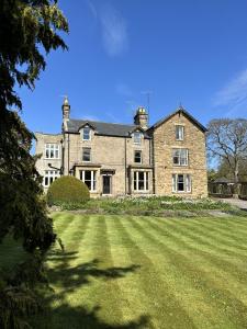 a large brick house with a large grass yard at The Beeches - Chatsworth Apartment No 2 - Sleeps 4 in Baslow