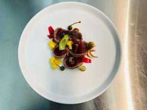 a white plate of food on a table at Mirodìa in Sternatia