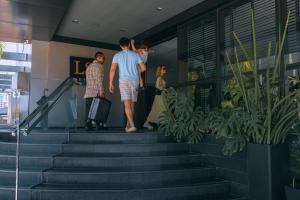 a group of people standing on the stairs at LS Hotel in João Pessoa